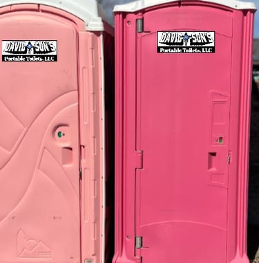 Two pink portable toilets from David & Son's Portable Toilets, LLC for event sanitation.