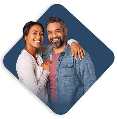 a man and woman smiling and hugging each other