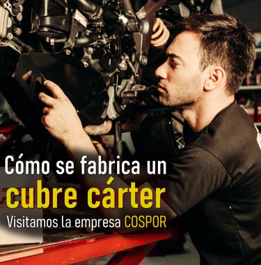 a man in a black shirt is working on a motorcycle