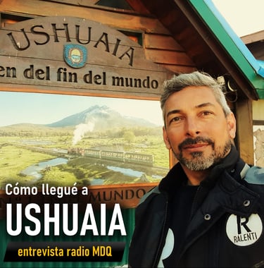 Ushuaia a man in a black jacket and a sign that says ushuala