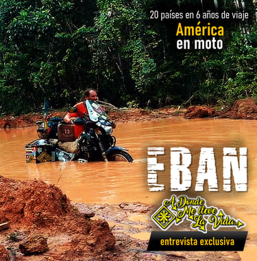 a man riding a motorcycle through a muddy road