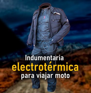 a man in a jacket and jeans standing in front of a mountain