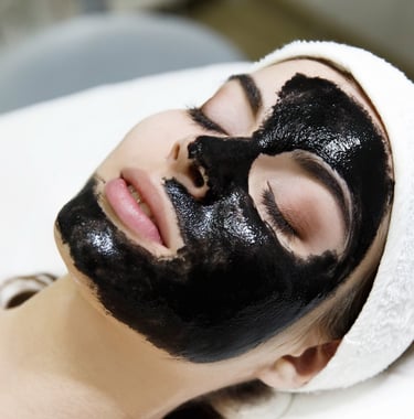 Girl with black mask lies on the table in spa saloon