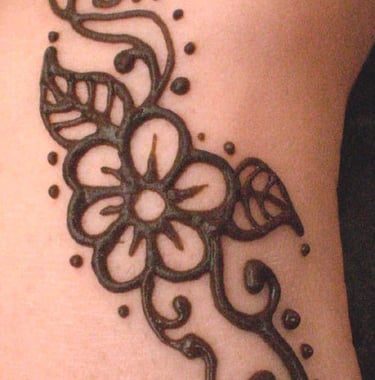 a henna tattoo on a woman's leg of a flower