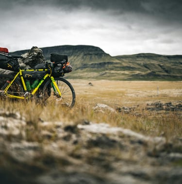 Loaded bicycle in mountains by Marek Piwnicki