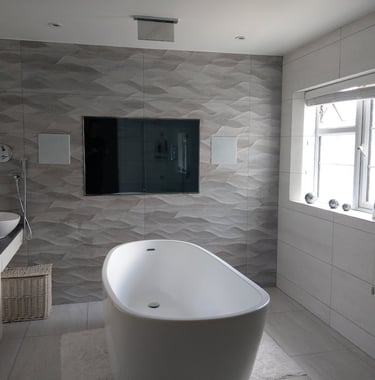 MountMyTV - Aquavision 65" TV, Bowers and Wilkins in-ceiling speakers in a bathroom