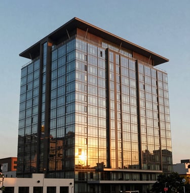 A luxurious architectural view of a modern hotel building in Brazzaville, Congo, during the golden hour. Reflective glass windows and warm sunset light hitting the facade. Professional urban photography.