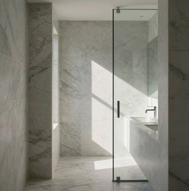Clean, architectural photography of a minimalist bathroom layout in Los Angeles. The composition emphasizes geometric lines, soft marble textures, and a flood of natural light reflecting off glass surfaces.