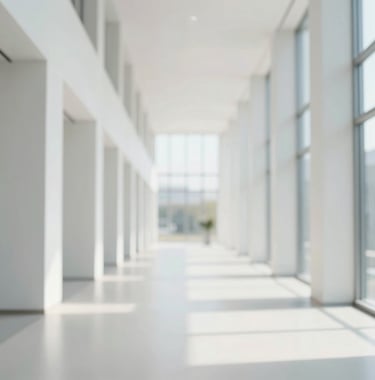 A long, bright architectural hallway with strong perspective lines leading toward a large window. The palette is dominated by light off-white (#F4F7FA) and grey-blue accents, symbolizing transparency, direction, and a forward-thinking path.