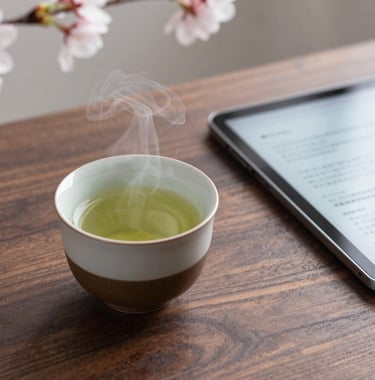 A steaming, artisan ceramic cup of green tea on a dark walnut table next to a sleek, modern digital tablet displaying Japanese text. Soft focus on cherry blossoms in the background. Minimalist photography.