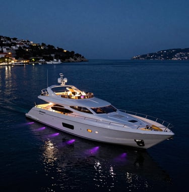 A stunning wide shot of a luxury yacht moored in a Mediterranean bay at night, illuminated for a wedding reception with elegant violet lights casting long shadows across the dark water.