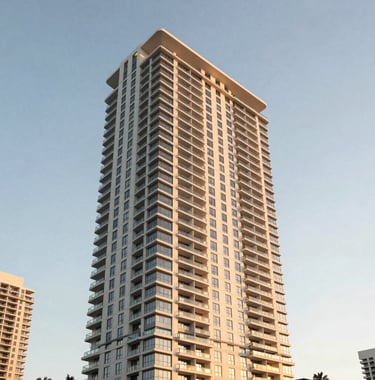 Exterior architectural photography of a luxury residential skyscraper in Brickell, Miami, during golden hour, reflecting a warm white and champagne gold palette against a clear sky.