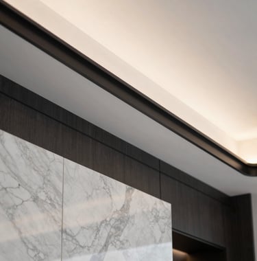 Close-up detail of a modern, premium interior design in a Miami luxury penthouse, featuring clean lines, marble textures, and strategic lighting in warm white and graphite black.