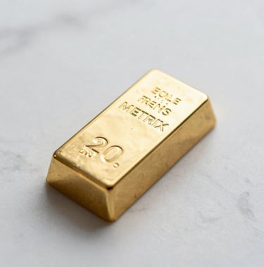 A macro shot of a gold bullion bar with the official Metrix hallmark, resting on a white marble surface in soft light.