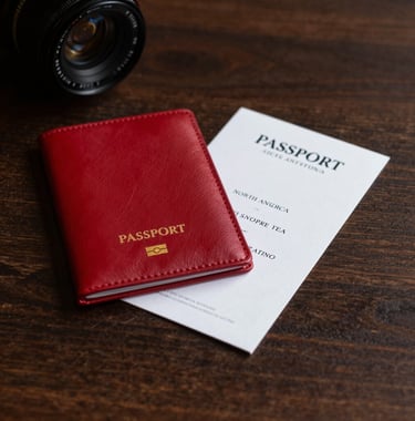 An elegant photography of a luxury travel coordination setting. A red leather passport holder and a white invitation card rest on a dark wood surface. The lighting is sophisticated and warm, capturing the essence of high-profile concierge services in North America.