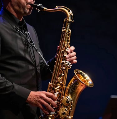 A professional jazz musician performing with a saxophone. Dramatic lighting highlighting the golden instrument against a black and deep navy background. Cinematic style.