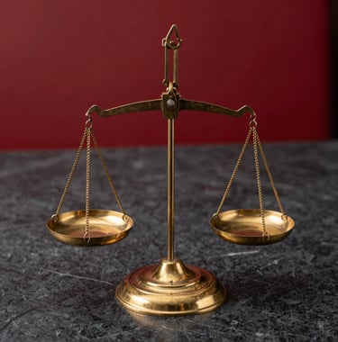 Macro photography of a set of classic brass balance scales on a dark charcoal marble surface, representing justice and financial balance. Crimson red background accents.