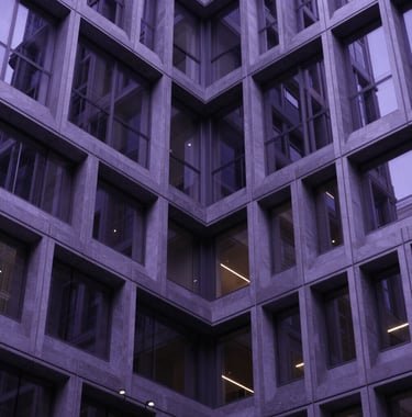 Sleek architectural detail of a high-tech building's atrium in North America, with a focus on geometric patterns and a cool, midnight purple color palette.