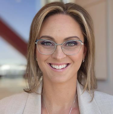 a woman in glasses and a white jacket