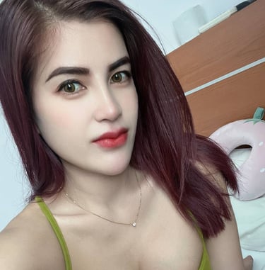 lady wearing a very low cut top showing tattooed right breast