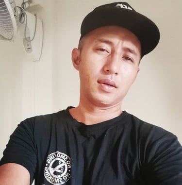 man wearing a cap taking a selfie