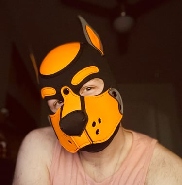 Man. posing wearing a pup mask.