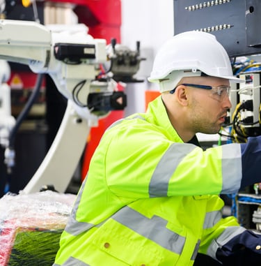 a man in a safety vest and safety glasses