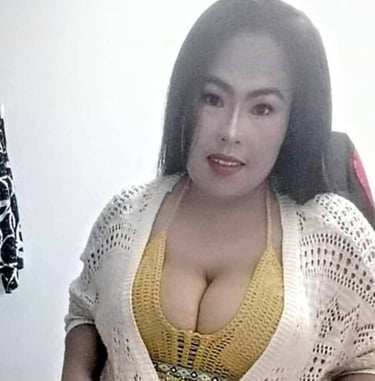 Lady wearing yellow top , black skirt and cream mesh design cardigan