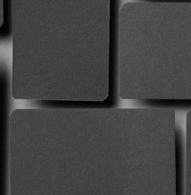 a black and white photo of a wall of squares of black squares