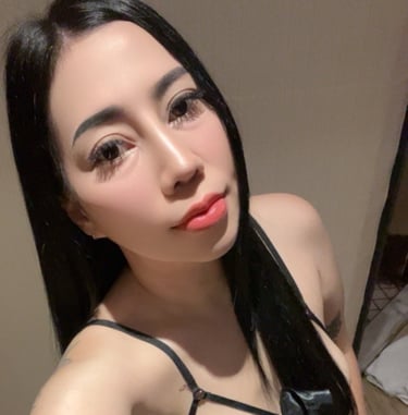 Lady wearing a black under garment and poised on her knees