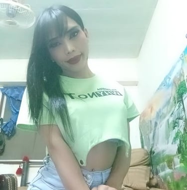 Ladyboy cropped green top and denim shorts with knee length red leather boots