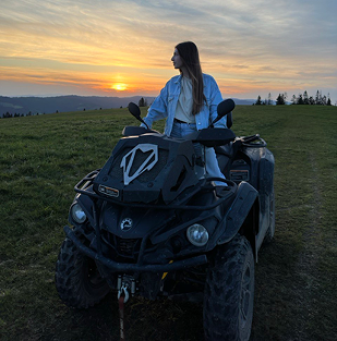 a woman sitting on a quad - atv atv