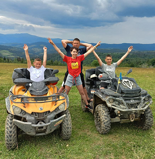 a group of people riding on four wheelers