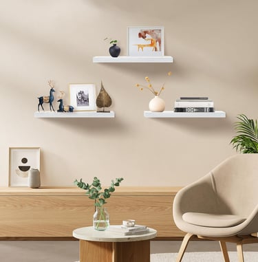 White floating shelves displaying plants, books, and modern home decor accessories