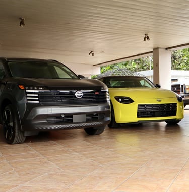 two cars parked in a garage with a man in a suit