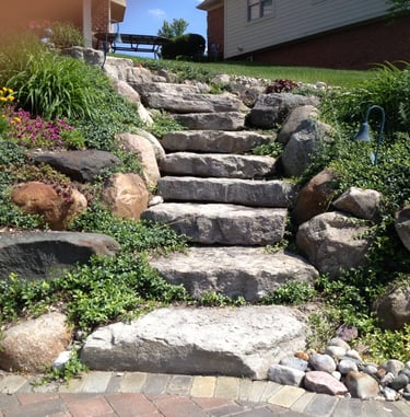 Leppek Landscape designed and installed natural ledge rock steps, retaining walls, perennials.