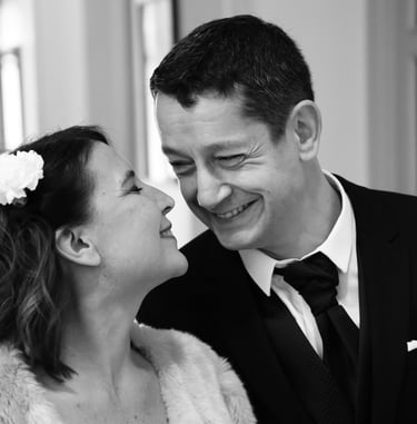 a man and woman are smiling and looking at each other