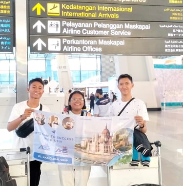 crew holding a AKA banner at an international airport 