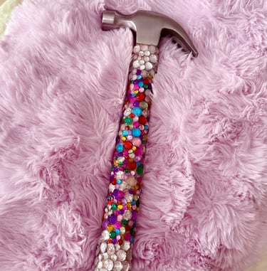 hammer covered in multicolored. rhinestones with silver rhinestones at the top and bottom 