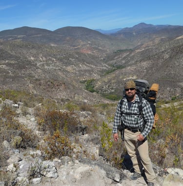 a man with a backpack on a mountain