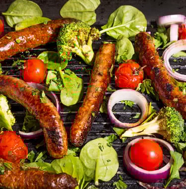 Sustainable plant-based, nutritionally-dense, hypoallergenic protein and fibre sausages with vegetables surrounding