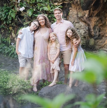 Family portrait surrounded by tropical plants at Umbul Sari Water Garden in Ubud Bali