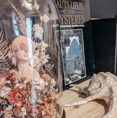 a glass dome with a lizard inside of it with an esoteric book
