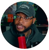 a man in a black hat and a red microphone