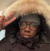 a man in a black jacket and glasses