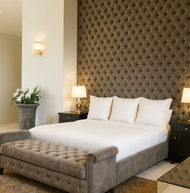 Tufted bed and bench with dark wall paneling, custom-designed by Solo Home Decor for a luxe bedroom.