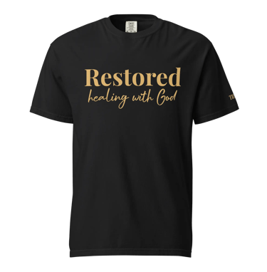 Black graphic t-shirt featuring Restored Healing with God in gold elegant typography.