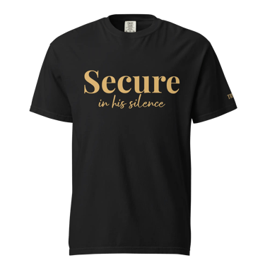 Black cotton t-shirt featuring the gold text Secure in his silence for faith-based apparel.