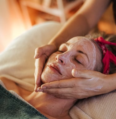 a woman getting a facial mask with a facial mask