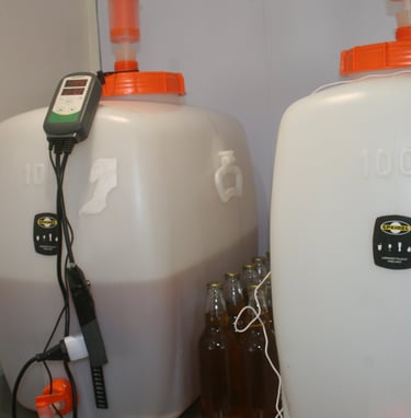 two large white containers with orange lids and a remote control